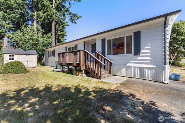 7138 Englewood Dr SE Unit 32, Olympia, WA 98513 - view of front of home featuring a storage unit, a front yard, and a wooden deck