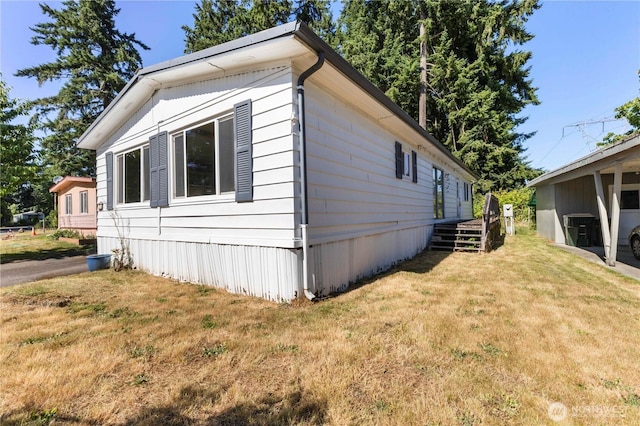 7138 Englewood Dr SE Unit 32, Olympia, WA 98513 - view of home's exterior with a yard and a central AC unit