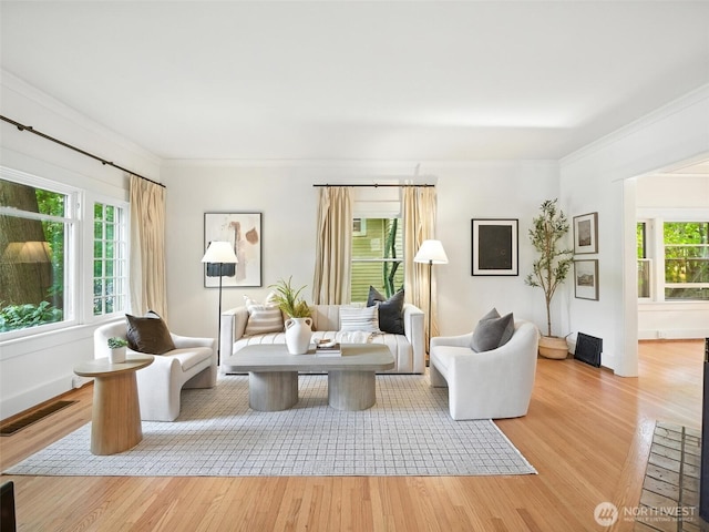 2555 Queen Anne Ave N, Seattle, WA 98109 - living area with wood finished floors, healthy amount of natural light, and ornamental molding