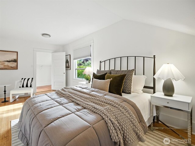 2555 Queen Anne Ave N, Seattle, WA 98109 - bedroom with light wood finished floors, vaulted ceiling, and a spacious closet