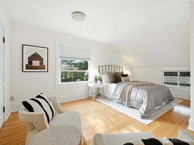 2555 Queen Anne Ave N, Seattle, WA 98109 - bedroom featuring wood finished floors and vaulted ceiling