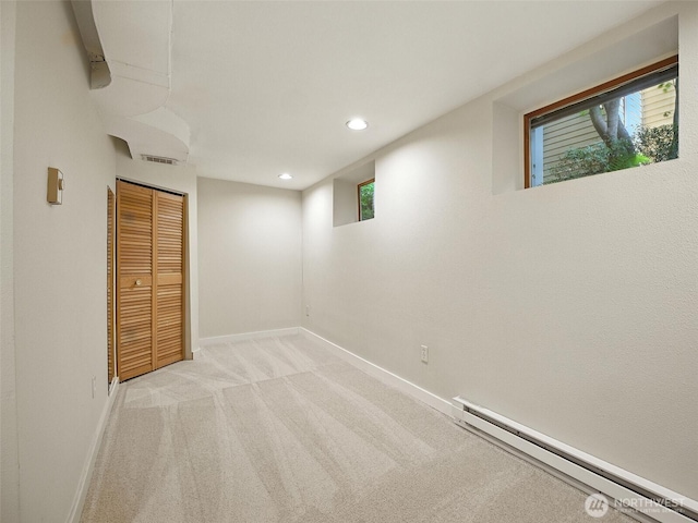 2555 Queen Anne Ave N, Seattle, WA 98109 - below grade area with a baseboard radiator, light colored carpet, and recessed lighting