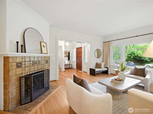 2555 Queen Anne Ave N, Seattle, WA 98109 - living room with a fireplace, ornamental molding, wood finished floors, and stairway