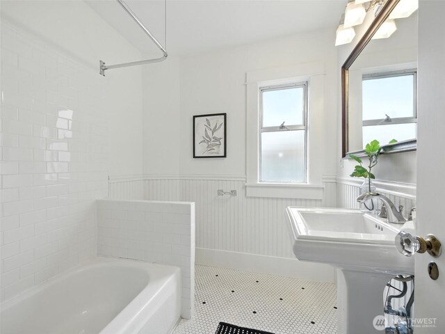 2555 Queen Anne Ave N, Seattle, WA 98109 - bathroom featuring a bath, wainscoting, and tile patterned floors