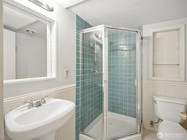 2555 Queen Anne Ave N, Seattle, WA 98109 - full bathroom with a shower stall, a wainscoted wall, and tile patterned floors