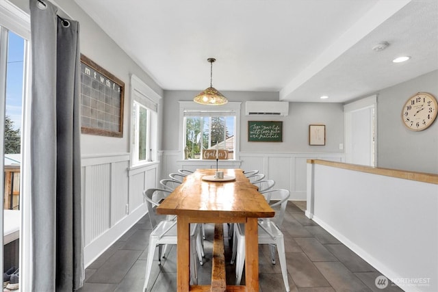 2819 W Olympic Ave, Spokane, WA 99205 - dining room featuring a wall mounted AC, wainscoting, dark tile patterned flooring, a decorative wall, and recessed lighting