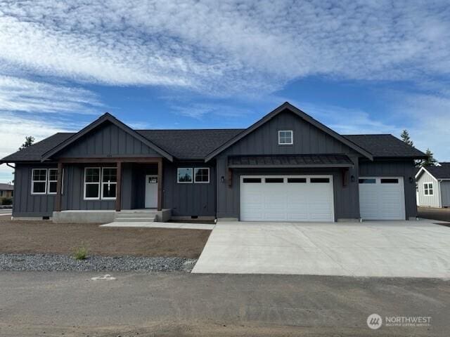 124 Sable Dr, Everson, WA 98247 - view of front of home with board and batten siding, a garage, and driveway