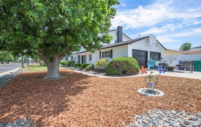 1609 Russell St, Wenatchee, WA 98801 - view of front of house with an attached garage, concrete driveway, and a chimney
