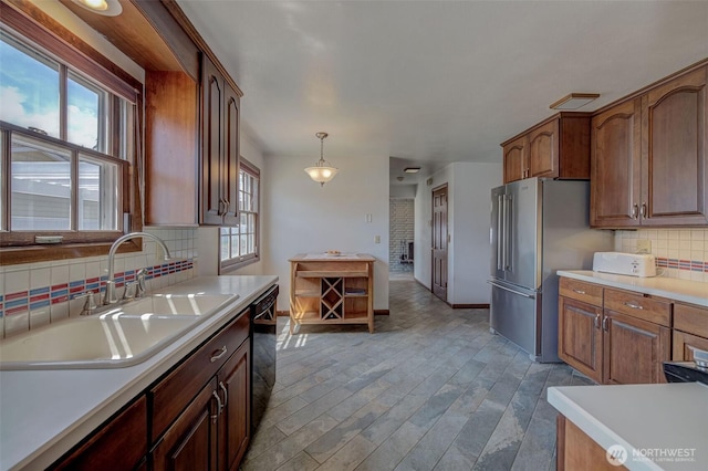 1609 Russell St, Wenatchee, WA 98801 - kitchen featuring backsplash, healthy amount of natural light, light countertops, and freestanding refrigerator