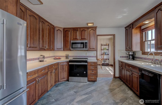 1609 Russell St, Wenatchee, WA 98801 - kitchen featuring stainless steel appliances, tasteful backsplash, light countertops, and light stone finish floors