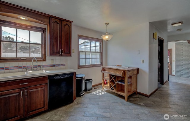 1609 Russell St, Wenatchee, WA 98801 - kitchen with black dishwasher, light countertops, backsplash, pendant lighting, and light stone finish floors