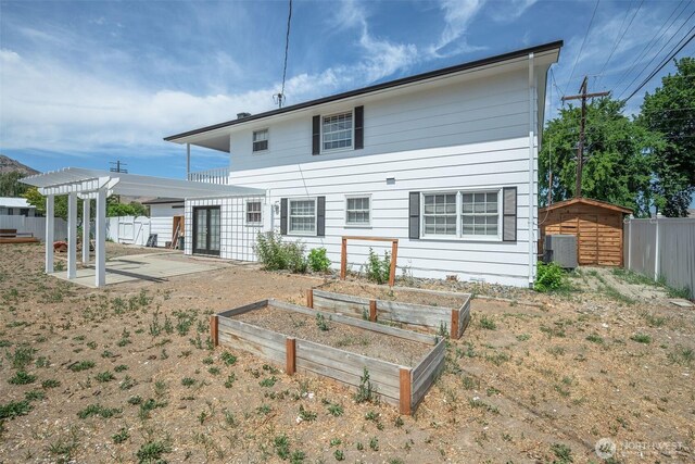 1609 Russell St, Wenatchee, WA 98801 - rear view of property with a garden, a shed, a patio, and a pergola