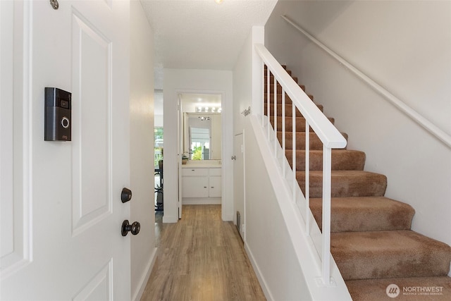 8823 Holly Dr Unit H206, Everett, WA 98208 - stairway featuring wood finished floors and baseboards