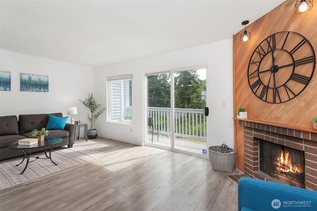 8823 Holly Dr Unit H206, Everett, WA 98208 - living room featuring wood finished floors and a brick fireplace