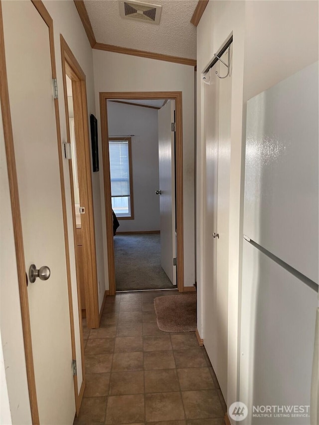 1200 Lincoln St Unit 117, Bellingham, WA 98229 - corridor featuring ornamental molding, carpet flooring, and a textured ceiling