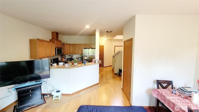 1317 52nd St NE Unit 1304, Auburn, WA 98002 - kitchen with stainless steel appliances, a peninsula, light wood finished floors, recessed lighting, and brown cabinetry
