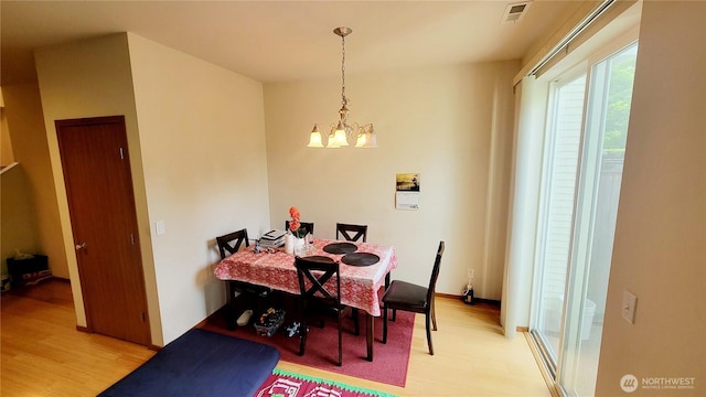 1317 52nd St NE Unit 1304, Auburn, WA 98002 - dining room with light wood-type flooring and a chandelier