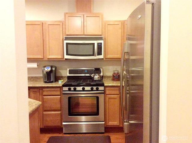 1317 52nd St NE Unit 1304, Auburn, WA 98002 - kitchen featuring appliances with stainless steel finishes, light brown cabinets, and light stone countertops