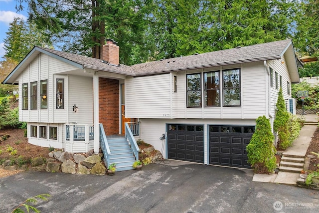 8475 SE 45th St, Mercer Island, WA 98040 - view of front of property with driveway, an attached garage, and a chimney