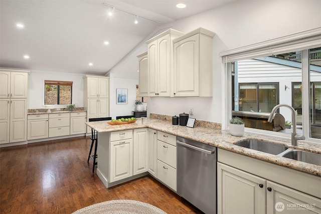8475 SE 45th St, Mercer Island, WA 98040 - kitchen featuring stainless steel dishwasher, vaulted ceiling, a peninsula, light stone counters, and a kitchen bar