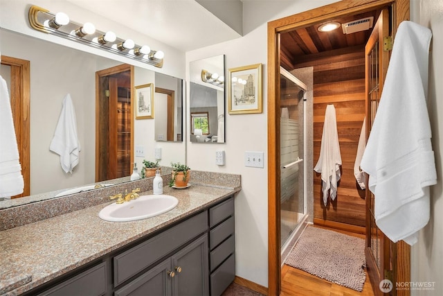 8475 SE 45th St, Mercer Island, WA 98040 - bathroom featuring vanity, a shower stall, and wood finished floors