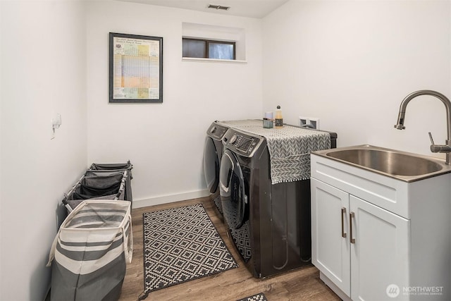 8475 SE 45th St, Mercer Island, WA 98040 - washroom featuring washing machine and dryer, wood finished floors, and cabinet space