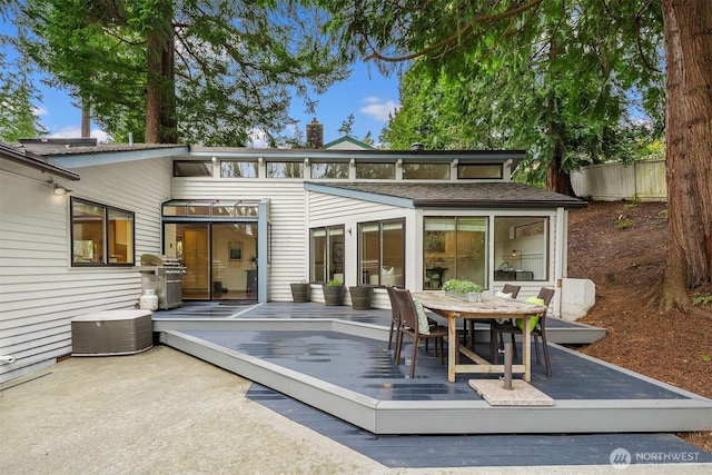 8475 SE 45th St, Mercer Island, WA 98040 - back of property with a wooden deck, outdoor dining area, and a chimney