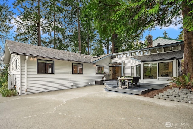 8475 SE 45th St, Mercer Island, WA 98040 - rear view of house with a patio area and roof with shingles