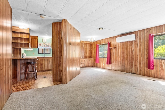 2400 Donovan Unit 67, Bellingham, WA 98225 - unfurnished living room with a wall mounted AC, wooden walls, and carpet flooring
