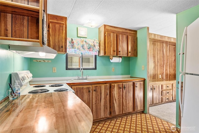 2400 Donovan Unit 67, Bellingham, WA 98225 - kitchen with white appliances, a textured ceiling, light countertops, and brown cabinets