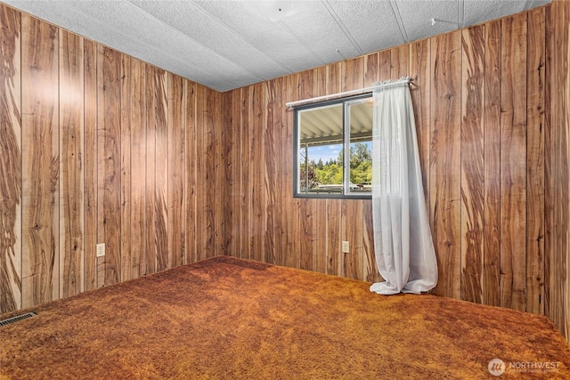2400 Donovan Unit 67, Bellingham, WA 98225 - empty room with wood walls and carpet floors