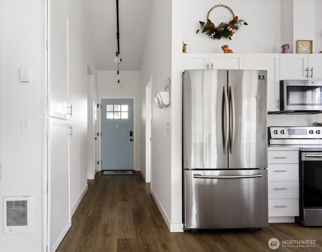 1664 Allyson St, Oak Harbor, WA 98277 - kitchen with stainless steel appliances, white cabinetry, dark wood finished floors, and lofted ceiling