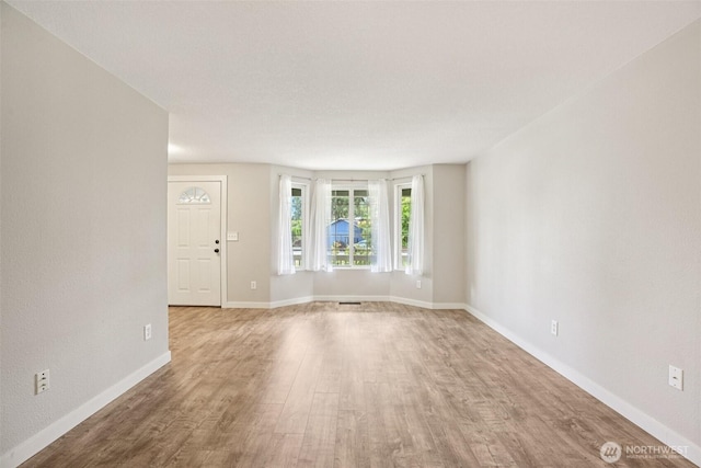 212 SW 2nd Ct, Battle Ground, WA 98604 - unfurnished living room with wood finished floors and baseboards