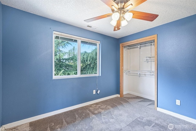 212 SW 2nd Ct, Battle Ground, WA 98604 - unfurnished bedroom featuring carpet floors, a closet, a textured ceiling, a textured wall, and a ceiling fan