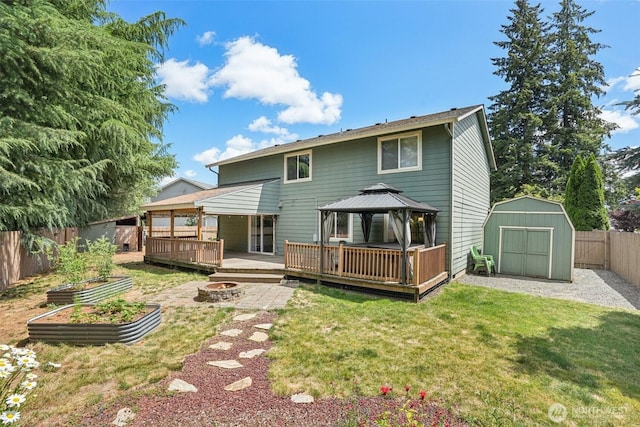 212 SW 2nd Ct, Battle Ground, WA 98604 - rear view of property featuring a gazebo, an outdoor fire pit, a shed, a fenced backyard, and a wooden deck