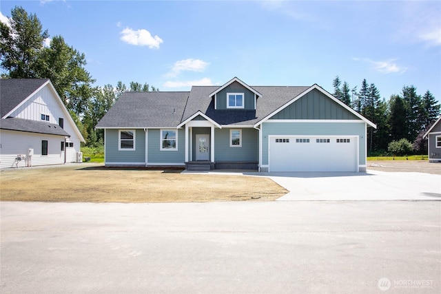1204 E Georgia Ln, Everson, WA 98247 - view of front of house featuring board and batten siding, concrete driveway, a garage, and a shingled roof