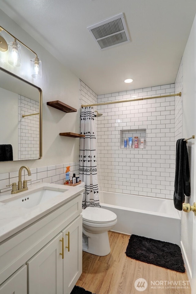 302 126th St S, Parkland, WA 98444 - full bath featuring vanity, wood finished floors, shower / tub combo with curtain, and tile walls