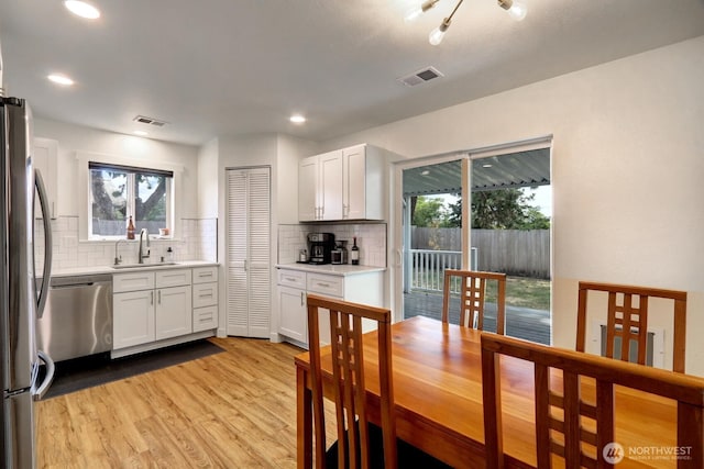 302 126th St S, Parkland, WA 98444 - kitchen with stainless steel appliances, decorative backsplash, plenty of natural light, and recessed lighting