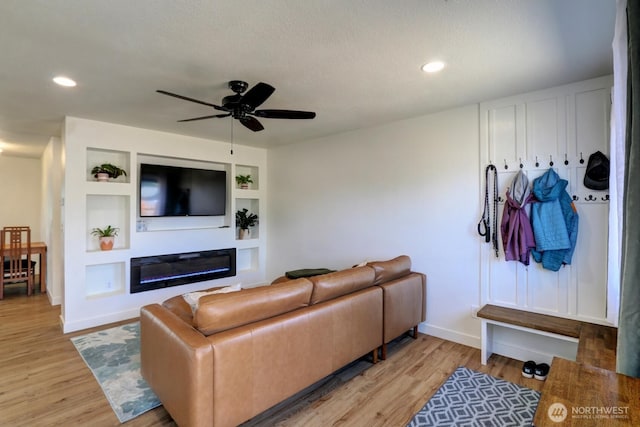 302 126th St S, Parkland, WA 98444 - living area featuring a glass covered fireplace, light wood-style flooring, ceiling fan, recessed lighting, and built in shelves