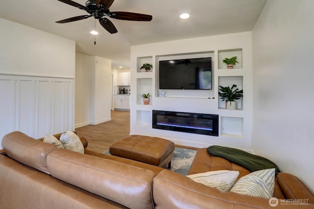 302 126th St S, Parkland, WA 98444 - living area featuring light wood-style flooring, a ceiling fan, a glass covered fireplace, and recessed lighting