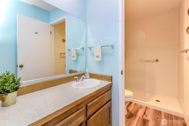 28313 Redondo Way S Unit 304, Des Moines, WA 98198 - bathroom with a walk in shower, wood finished floors, and vanity