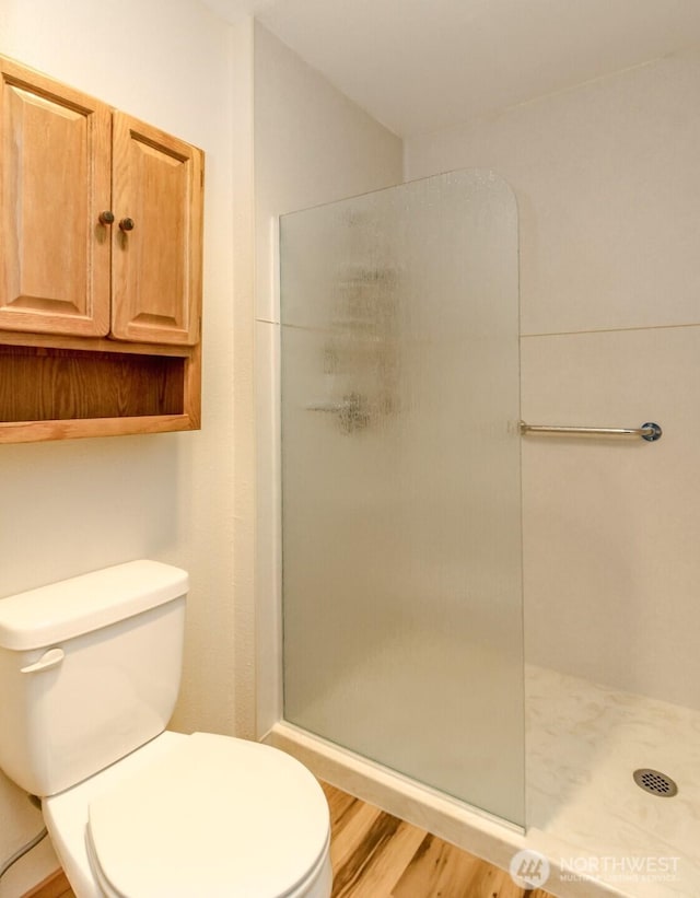 28313 Redondo Way S Unit 304, Des Moines, WA 98198 - full bathroom featuring a stall shower and wood finished floors
