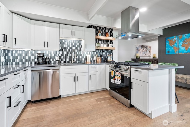 1432 Weathervane Dr, Fircrest, WA 98466 - kitchen featuring stainless steel appliances, island exhaust hood, a peninsula, tasteful backsplash, and beam ceiling
