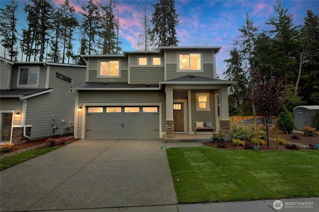 13701 60th Ave E, Edmonds, WA 98026 - view of front of house featuring a garage, driveway, a lawn, board and batten siding, and stone siding