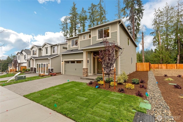 13701 60th Ave E, Edmonds, WA 98026 - view of front facade with concrete driveway, an attached garage, a residential view, board and batten siding, and stone siding