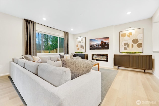 13701 60th Ave E, Edmonds, WA 98026 - living area featuring light wood-style flooring, a glass covered fireplace, and recessed lighting