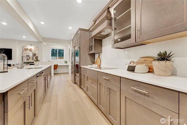 13701 60th Ave E, Edmonds, WA 98026 - kitchen with glass insert cabinets, light wood-style flooring, backsplash, light countertops, and recessed lighting