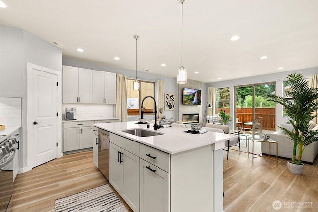 12433 SE 256th Pl Unit 4, Kent, WA 98030 - kitchen with stainless steel appliances, light wood-type flooring, light countertops, backsplash, and recessed lighting