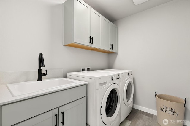 12433 SE 256th Pl Unit 4, Kent, WA 98030 - laundry room with cabinet space, washing machine and clothes dryer, and light wood-style floors