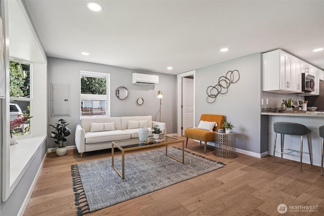 14427 156th Ave SE, Renton, WA 98059 - living room featuring electric panel, a wall mounted air conditioner, light wood-type flooring, and recessed lighting